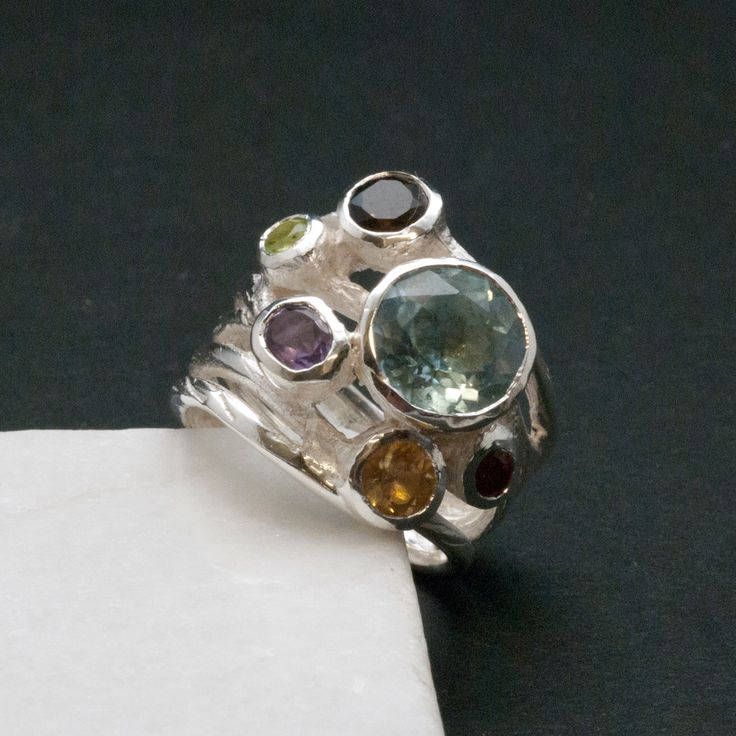 Big Multi Gemstone Statement Ring, Glamorous Wide Band 925 Silver Natural Gemstones, Blue Topaz High Fashion Ring, Fine Jewelry Gift for Her by SunSanJewelry on Etsy https://www.etsy.com/listing/475609499/big-multi-gemstone-statement-ring Unique Birthstone Gemstones For Jewelry Making, Unique Birthstones For Jewelry Making, Fusion Style Oval Multi-stone Gemstones, Anniversary Multi-stone Round Gemstones, Sterling Silver Multi-stone Topaz Ring, Unique Multi-stone Sapphire Ring For Anniversary, Unique Sterling Silver Sapphire Ring With Gemstone Accents, Fine Jewelry Multi-stone Gemstones In Sterling Silver, Unique Silver Multi-stone Cluster Ring