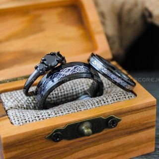 two wedding rings sitting on top of a wooden box