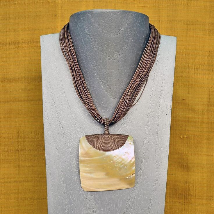 MOTHER OF PEARL SHELL WAXED LINEN CORD NECKLACE - BROWN DETAILS This boho mother of pearl necklace was designed using waxed linen cord and a huge Mother of pearl shell pendant. Handmade and imported from Thailand. 301635-BROWN Boho style necklace 18" long Mother of pearl shell pendant - 4" x 2 1/2" 5 strands of waxed linen cord Knotted waxed linen clasp Imported MATERIAL HIGHLIGHTS: Mother of Pearl: Calming, brings inner wisdom, mental clarity, intuition, sensitivity, imagination, adaptability, Boho Mother, Boho Style Necklaces, Long Necklace Boho, Mother Of Pearl Jewelry, Seashell Jewelry, Inner Wisdom, Mother Of Pearl Necklace, Macrame Necklace, Seed Bead Necklace