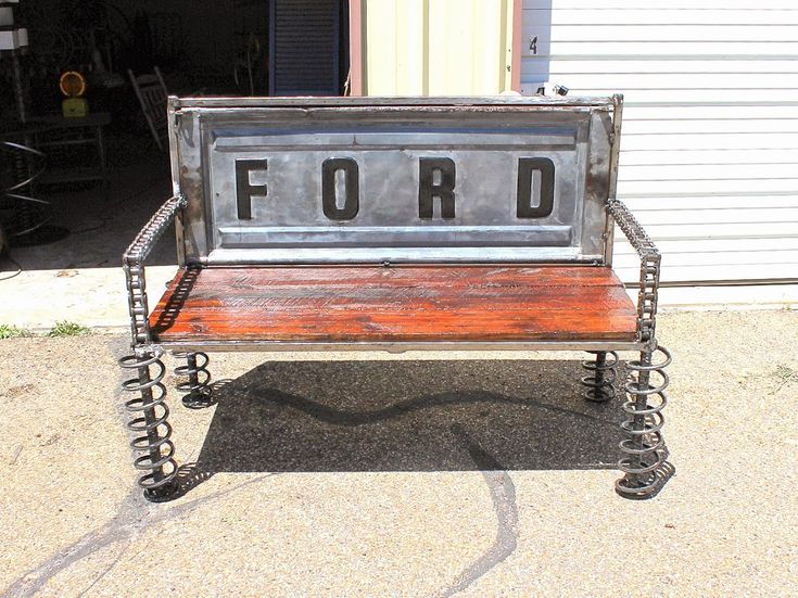 a bench made out of metal and wood with the word ford on it's back