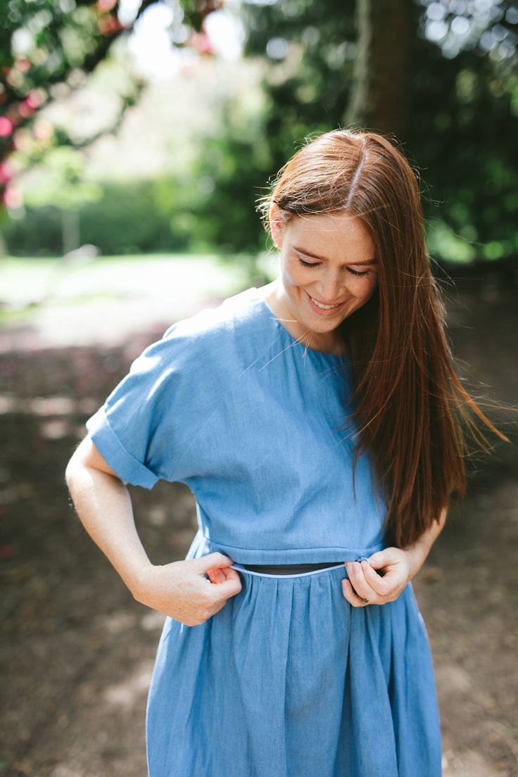 A denim look nursing dress designed for breastfeeding and maternity. A smock length dress with rolled short sleeves  and a casual fit. At Ruma Breastfeeding Wear we design dresses for nursing and maternity that match your pre baby style. Dress for breastfeeding and maternity with a unique two way, hidden zip that can be opened from either side allowing you to nurse your baby comfortably. We've added a quick video to show you how the zip works. This dress is a midi length with a tiered skirt and Summer Maternity Dress Nursing Friendly, Cotton Maternity Dress With Short Sleeves, Short Sleeve Cotton Maternity Dress, Modest Short Sleeve Maternity Dress For Summer, Nursing Friendly Short Sleeve Maternity Dress, Summer Maternity Dress With Short Sleeves, Summer Cotton Maternity Dress Nursing Friendly, Relaxed Fit Denim Dress With Short Sleeves, Blue Nursing-friendly Maternity Dress With Short Sleeves