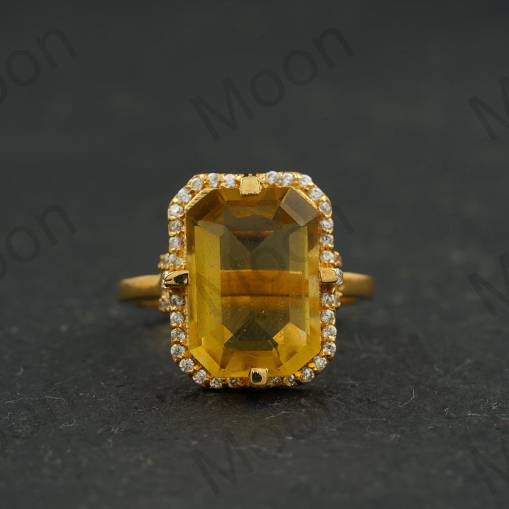 Large Citrine Ring Vintage Citrine Engagement Ring 14K Gold Emerald Cut Citrine Ring November Birthstone Statement Ring Halo Diamond Ring ◈ Item Details ◈ Metal: 925 Sterling Silver   Style: Gemstone Ring Main Stone: Citrine ( Lab-Created ) Main Stone Color: Yellow  Main Stone Shape: Emerald  Birth Month: November Secondary Stone: Simulated Diamond Secondary Stone Color: White Secondary tone Shape: Round ABOUT GEMSTONE - ♥ Purification ♥ Serenity ♥ Protection ♥ Wisdom ♥ Balance ♥ Strength ♥ Friendship ♥ Love ♥ Positive thinking ♥ Sensitivity S I L V E R J E W E L R Y C A R E Silver is not the best friend of oxygen and sulfur; it can be oxidized and tarnished from time to time it is the nature of silver. To keep the silver shiny and prevent it from oxidizing fast, we would recommend the fol Yellow Gold Citrine Topaz Ring, Emerald Cut, Yellow Topaz Center Stone Ring In 14k Gold, Gold Gemstones With Halo Setting In Fine Jewelry Style, Citrine Gemstone Wedding Ring, Citrine Diamond Ring With Accent Stones In Yellow Gold, Yellow Gold Citrine Diamond Ring With Accent Stones, Yellow 14k Gold Diamond Ring, 14k Gold Yellow Diamond Ring, Gold Topaz Ring With Halo Setting In 14k Gold