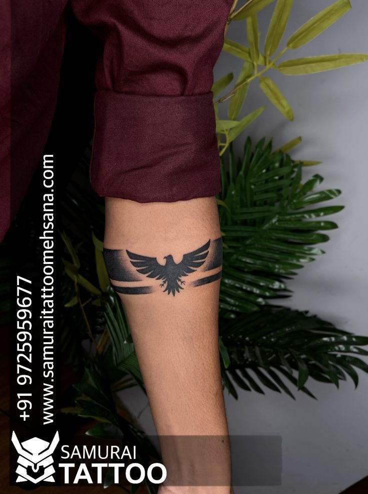 a man with a tattoo on his leg and arm is standing in front of a plant