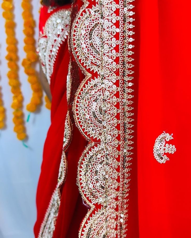 Beautiful Red Georgette Chiffon saree with hand Sabyasachi designer gotta patti and Zardozi flowers in the body. comes with 2 blouses - one sticthed - size 38-42 , back closure , padded, half sleeves. And a blouse fabric. This saree is ready to wear with falls,pico and beautiful handwoven tassels , and unstitched blouse fabric is included. Note: Colors that show up on your screen may vary slightly from the actual product due to variations in settings. Also, the actual product may appear to be different hues depending on the ambience lighting. Note: There may be very slight inconsistencies such as in the weave/motiff work, there being characteristics are not considered defects. Any jewelry shown is for general purpose only and is not included with the saree. Traditional Georgette Blouse For Eid, Traditional Semi-stitched Blouse Piece With Gota Work, Georgette Blouse For Eid Puja, Festive Gota Work Georgette Blouse, Georgette Blouse With Dupatta For Festivals, Elegant Dupatta With Mirror Work For Traditional Ceremonies, Gota Work Georgette Blouse Piece In Traditional Drape, Traditional Gota Work Georgette Blouse Piece, Traditional Georgette Blouse Piece With Gota Work