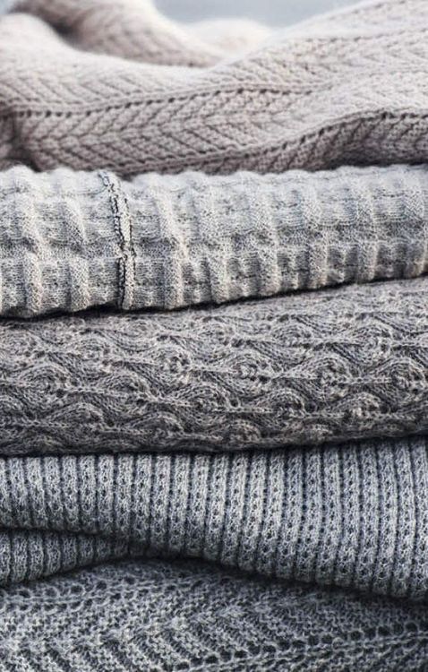 several sweaters stacked on top of each other