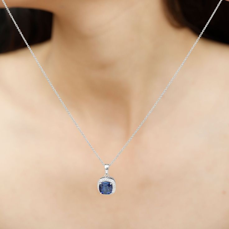 Product Details Surprise your significant other with a graceful gift: the Created Blue Sapphire Pendant Necklace. This elegant piece of fine jewelry features a Cushion Cut Created Blue Sapphire at its center, surrounded by a halo of Round Cut Zircon Stones. The halo pendant is crafted from Solid Gold, adding to its sophistication. This Classic Pendant Necklace is a timeless addition to any womans jewelry collection. Product Information SKU SHP-PENDANT082020001 Length 18.2 mm Width 11.4 mm Weight Classic Pendant Necklace, Sapphire Pendant Necklace, Blue Sapphire Pendant, Sapphire Necklace Pendants, Halo Pendant, Sapphire Pendant, Statement Pendant, Cushion Cut, Blue Sapphire