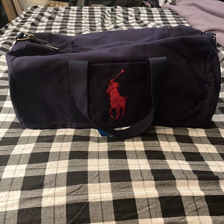 Navy Blue With Red Logo. Small Pocket With Zipper Inside For Keys, Wallet, Phone Etc.. Has A Strap To Wear Across The Body. Blue Shoulder Bag With Embroidered Logo For Travel, Casual Blue Shoulder Bag With Embroidered Logo, Everyday Blue Bag With Embroidered Logo, Casual Shoulder Bag With Embroidered Logo For Travel, Casual Travel Shoulder Bag With Embroidered Logo, Ralph Lauren Casual Everyday Bags, Casual Ralph Lauren Shoulder Bag For Daily Use, Ralph Lauren Casual Tote Shoulder Bag, Casual Ralph Lauren Tote Shoulder Bag