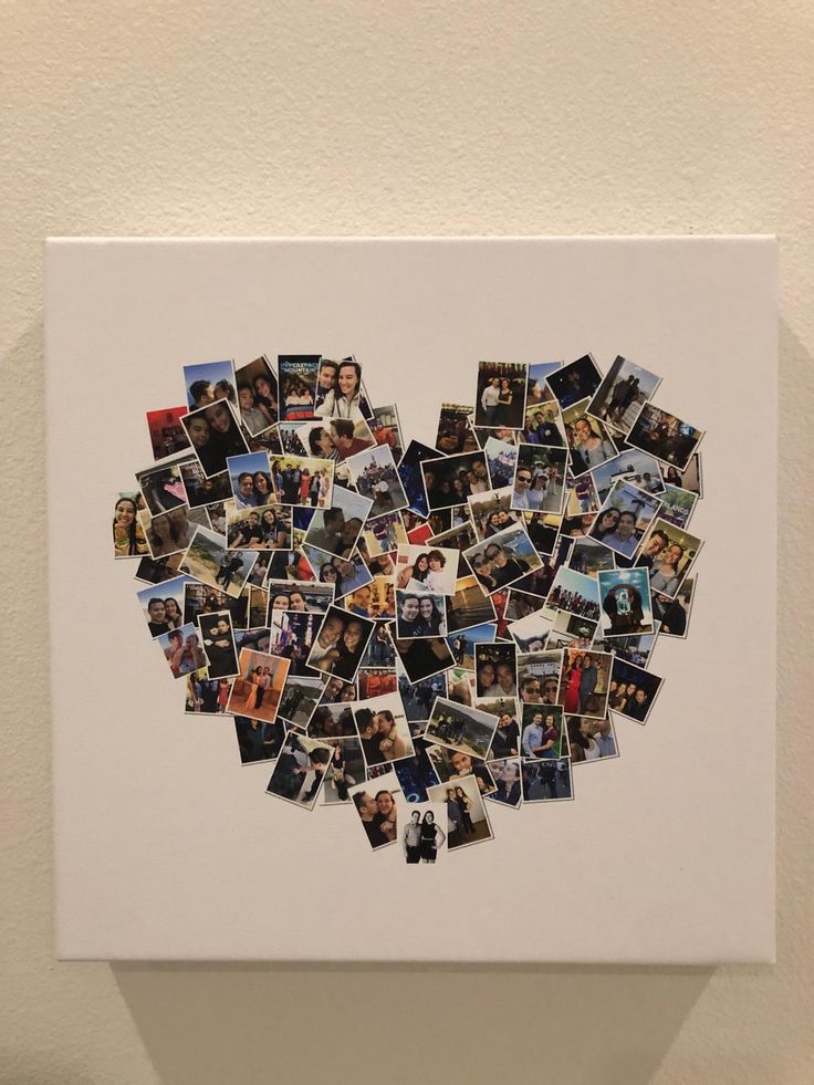 a heart made out of photos on a white wall