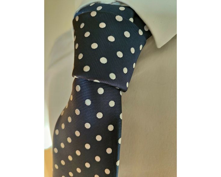 Men's luxurious Navy silk necktie, decorated with woven White polka dots. A classic design suitable for all occasions from work to weddings. The polka dot detail is woven and not printed, producing a high quality finish. This excellent quality, handmade tie would make the ideal gift all year round. This tie has a blade width of approximately 8cm. This tie is dispatched in protective wrapping and we offer free shipping within the UK. We strive to offer the best customer service available. If you Classic Polka Dot Ties For Business, Polka Dot Standard Tie For Business, Formal Polka Dot Standard Tie, Polka Dot Standard Tie For Formal Occasions, Business Polka Dot Ties, Polka Dot Ties For Black Tie Occasions, Polka Dot Ties For Black Tie Events, Elegant Polka Dot Tie For Black Tie Events, Scarf Dress