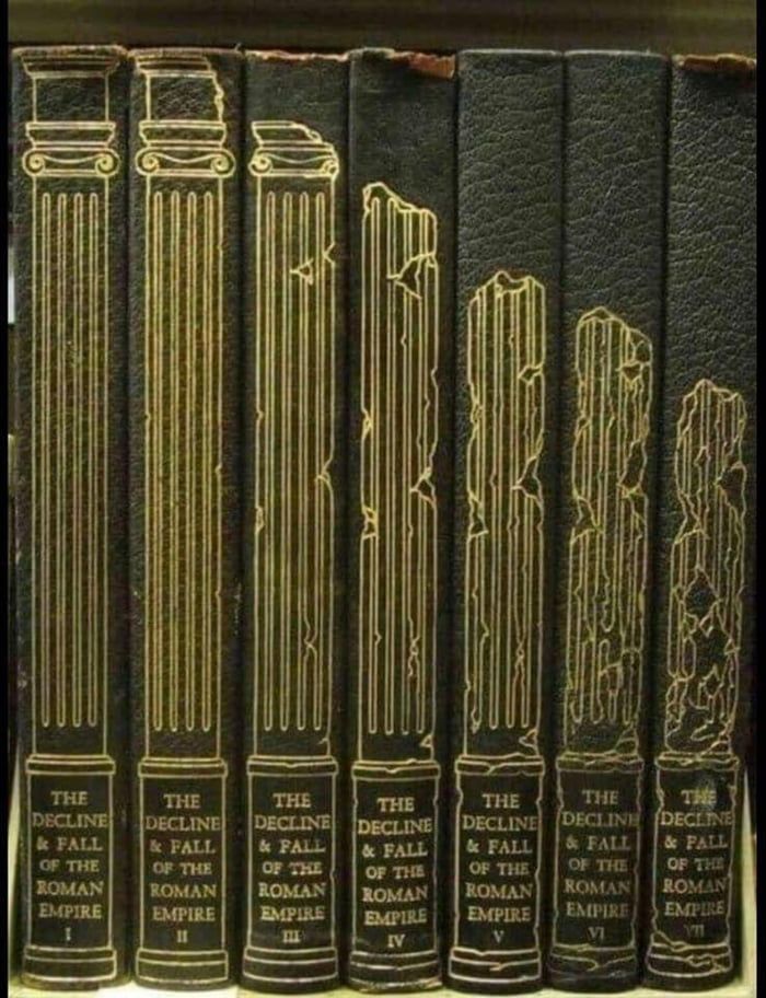 a row of black books sitting on top of a book shelf next to each other