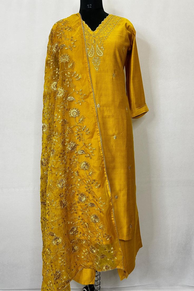 Silk Blend Mustard Embroidered Straight Kurta With Trousers and Dupatta Indian Wedding Wear Salwar Kameez / Indian Wedding Dress / Plus Size Cotton Kurta Dress Traditional Indian Wear / Salwar Kameez Dupatta / Kurti Palazzo Set The set contains: 1 Straight Kurta 1 Trousers 1 Dupatta Kurta: The mustard yellow straight Kurta has a V neck design with embroidered details in front. The Kurta measures till calf length and has straight hemline. Sleeve length :  3/4 Sleeves Trousers :  Solid trousers has partially elasticated waistband and slip on closure. Also comes with two pockets.  Dupatta : Embroidered Dupatta Material : Kurta :  Silk Blend Trousers :  Silk Blend Dupatta : Silk Blend Fabric Care : Hand wash Please see the size information below to choose a perfect size for yourself:  (size in Festive Slub Silk Churidar With Resham Embroidery, Slub Silk Sets With Dori Work For Wedding, Gold Embroidered Slub Silk Sets, Embroidered Gold Slub Silk Sets, Slub Silk Wedding Sets With Dori Work, Yellow Embroidered Slub Silk Unstitched Suit, Yellow Embroidered Unstitched Slub Silk Suit, Slub Silk Kurta With Traditional Drape For Wedding, Yellow Slub Silk Salwar Kameez With Dori Work