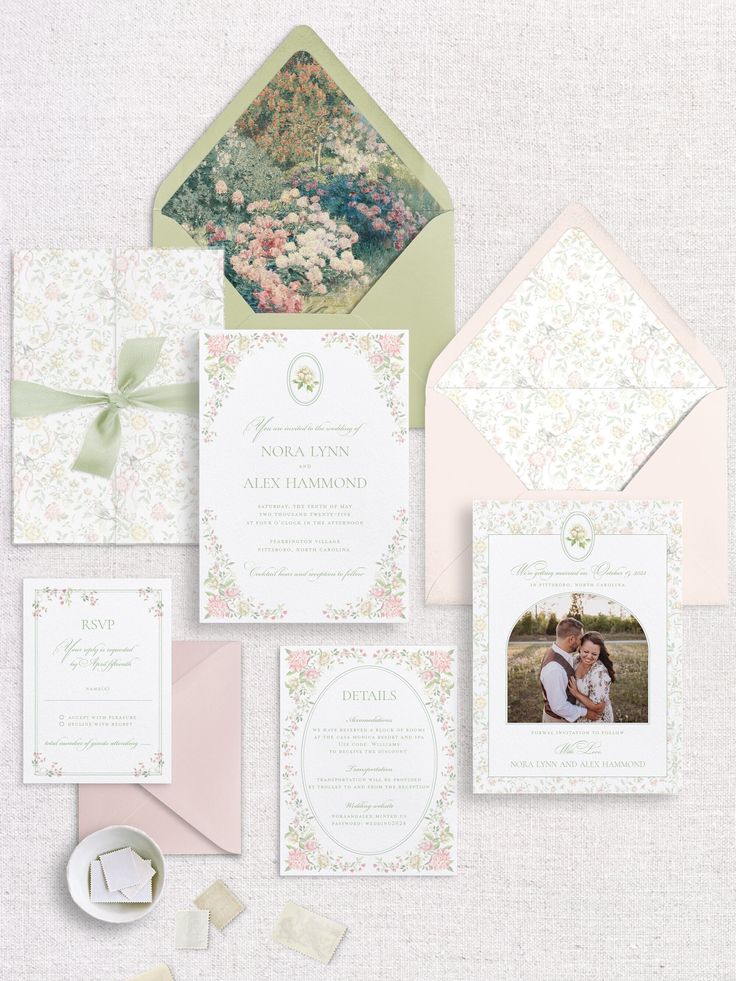 the wedding stationery is laid out on top of each other, including two envelopes and