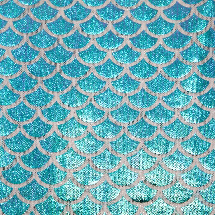 the back side of a blue and silver mermaid scales pattern on an upholstered fabric