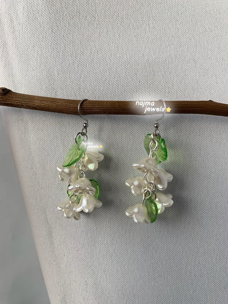 two pairs of green and white flower earrings