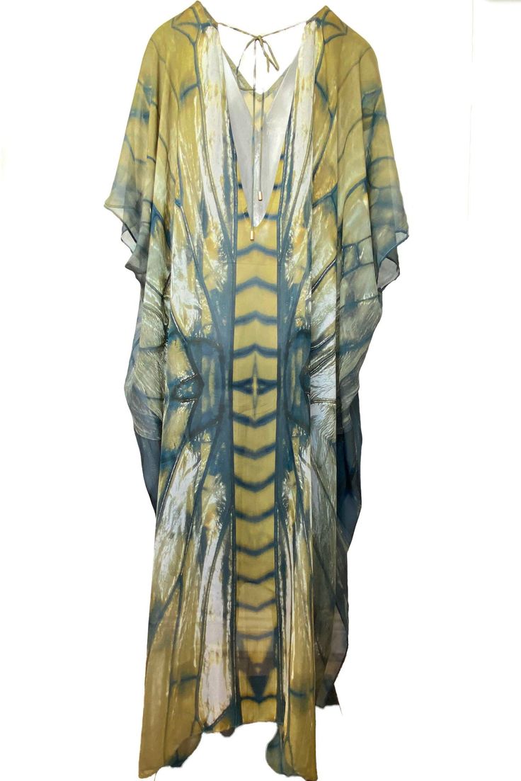 Freya Ashtanga Kaftan, this beautiful v-neck printed caftan in pure silk is cut oversized for an elegant drape and voluminous movement. Featuring a deep v-neckline and adjustable tie at the back. This dress can be transformed from day to night. Wear it as evening wear or as part of your beach outfit. 100% Silk Dry clean Handmade in Ireland FREYA PRINT: A dragonfly inspired print with shiny, iridescent, delicate and intricate wings in an ombre palette of metallics, antique gold, copper, bronze, c Elegant V-neck Kimono For Beach Cover-up, Chic Printed V-neck Kaftan, Elegant Yellow Silk Kaftan, Green Silk V-neck Kimono, Oversized Silk Bohemian Kaftan, Chic Silk Kaftan For Beach Cover-up, Chic Silk V-neck Kaftan, V-neck Printed Kimono For Festivals, Elegant V-neck Kaftan For Vacation