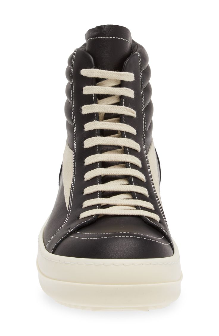 Crafted from full-grain leather and suede, this high-top sneaker is quintessentially Rick Owens with its blunted toe, dramatic lacing and shark-tooth sole. Drawing inspiration from vintage silhouettes and color schemes, this boldly topstitched shoe blends modern comfort with a timeless aesthetic. Lace-up style Leather upper and lining/rubber sole Made in Italy Designer Shoes Designer High-top Sneakers With Contrast Sole, Black Calf Leather High-top Sneakers For Streetwear, White Sole High-top Sneakers In Calf Leather, Calf Leather High-top Sneakers With White Sole For Streetwear, Custom High-top Calf Leather Sneakers With Rubber Sole, Calf Leather High-top Sneakers For Streetwear, Modern Calf Leather High-top Sneakers For Streetwear, Modern Calf Leather Lace-up High-top Sneakers, Lace-up High-top Sneakers In Calf Leather For Streetwear