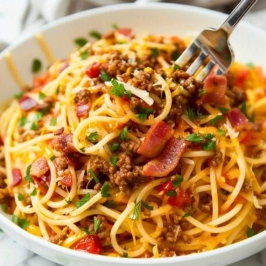 a white bowl filled with spaghetti and meat