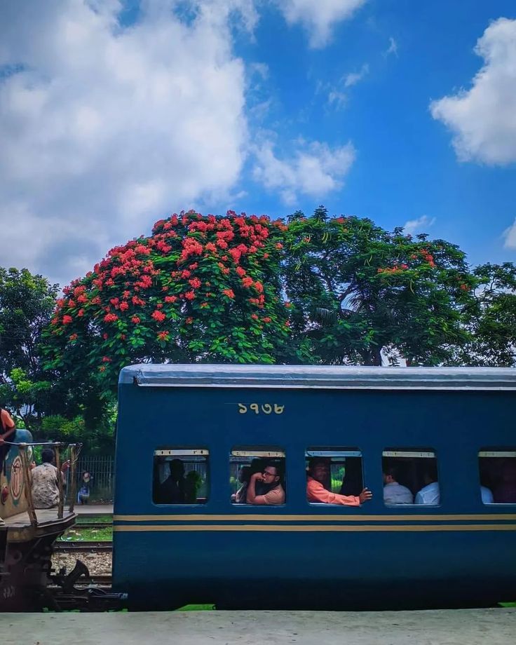 people are riding on the back of a blue train