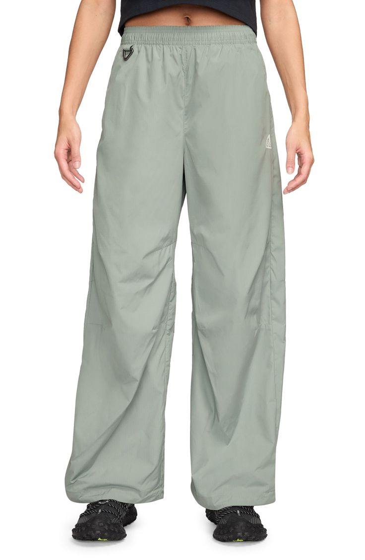 With a loose fit and lightweight, UV-blocking fabric, these pants are what you need for adventures far afield or closer to your own backyard. 31" inseam; 25" leg opening; 17" front rise; 17" back rise (size Medium) Elastic waist Front slant pockets; back snap-welt pocket Key carabiner UPF 50+ sun protection 93% polyester, 7% spandex Machine wash, tumble dry Imported Nike Cargo Pants For Outdoor, Nike Green Bottoms, Nike Relaxed Fit Bottoms For Outdoor, Sporty Green Parachute Pants For Hiking, Nike Wide Leg Pants With Elastic Waistband, Green Wide Leg Parachute Pants For Outdoor, Functional Wide Leg Bottoms For Outdoor Activities, Outdoor Green Wide Leg Parachute Pants, Green Wide Leg Nylon Bottoms