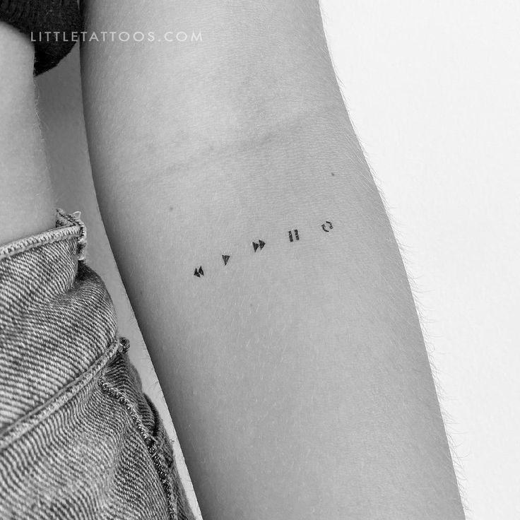 a couple of tattoos that are on the arm and one is written in small letters