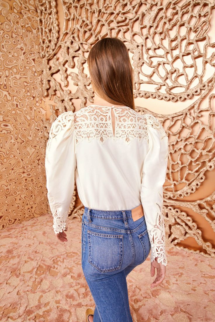 Made from our luxurious Victorian cotton-silk, the Aura Blouse is adorned with intricate Battenberg lace panels that create a decorative floral pattern along the yoke and sculptural long sleeves. It is a timeless pearly white, has a relaxed fit, and fastens with a buttoned keyhole at the back. Composition: 70% Cotton, 30% Silk Pair with our Lou Jean and Mini Floret Stud to complete the look. Explore more from our Victorian Cotton Silk Lace Collection. Timeless Pearly, Madewell Fall, White Lace Long Sleeve, Battenberg Lace, Nyc Boutiques, Lace Collection, Lace Blouse Long Sleeve, Drawn Thread, Silk Lace