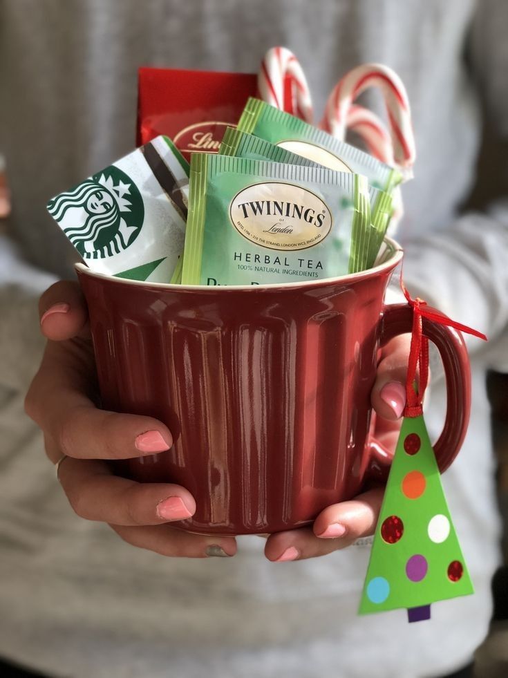 a woman holding a red mug filled with coffee and candy