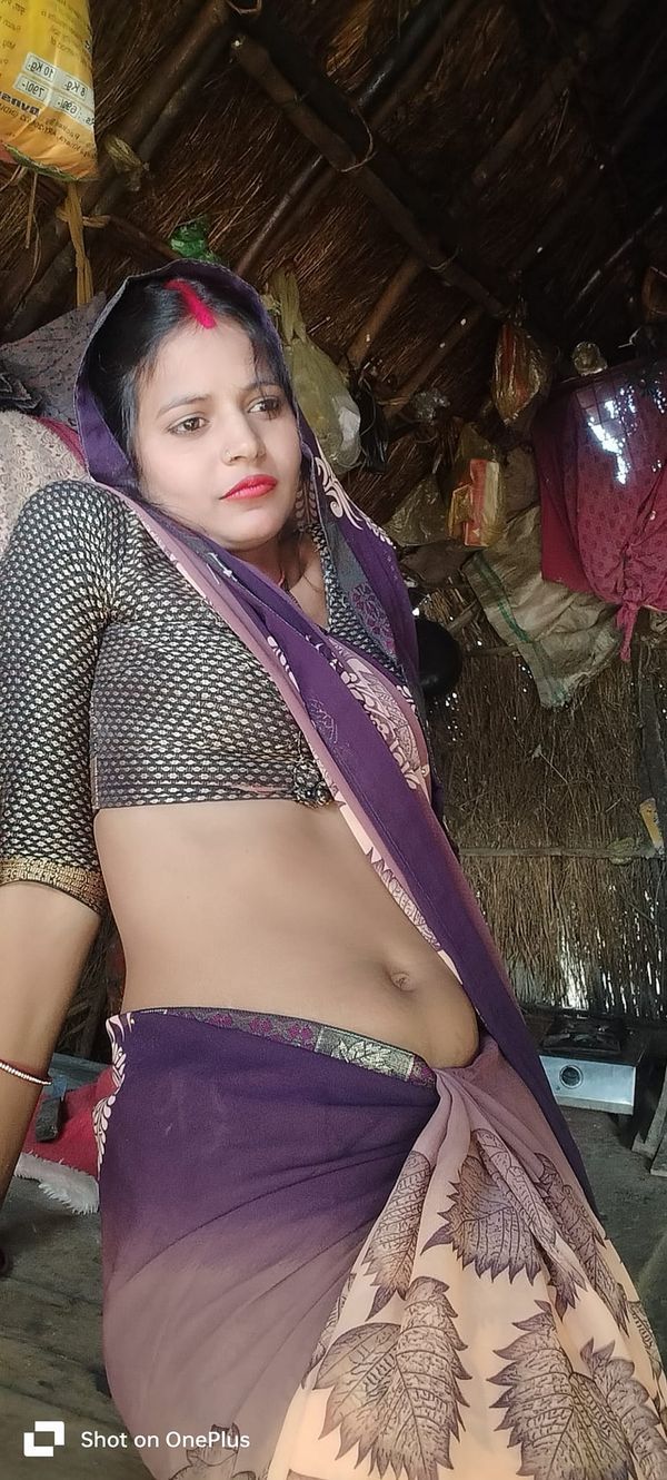 a woman in a sari is posing for the camera with her belly exposed and hands on her hips