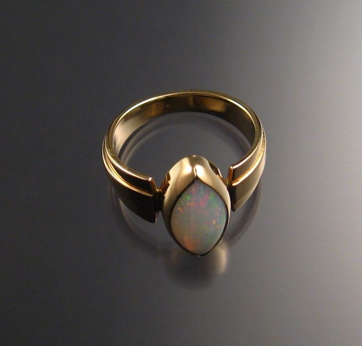 This colorful Brazilian Opal is a beautiful crystal (transparent) matrix. It is all solid and nice and thick so it will really last with ordinary care. Bezel set like all opals should be. The stone measures 7x13 mm. Set in 14k yellow gold, size 7 3/4. Modern Formal Opal Jewelry, Modern 14k Gold Opal Ring For Formal Occasions, Modern 14k Gold Opal Ring For Formal Events, Opal Rings With Polished Finish For Formal Occasions, Formal Opal Rings With Polished Finish, Modern Formal Opal Ring With Cabochon, Modern Formal Cabochon Opal Ring, Formal Modern Opal Cabochon Ring, Classic Opal Jewelry With Polished Finish