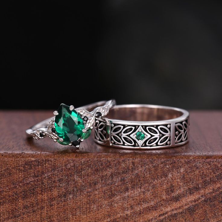 Here we have a Vintage Green Emerald Couples Ring Silver Ring Nature Inspired His and Hers Wedding Band Leaf Design Ring For Couples Anniversary Rings . ITEM DESCRIPTION ✦ Handmade, high-quality item! ✦ Material: Sterling Silver/10K/14K/18K/Platinum ►Sold as a two-piece set ►His ring is Sterling Silver with branch leaf design ►Center stone: 2mm Emerald ►His band width: 5mm ►Her ring is Sterling Silver.(can be made in 10/14/18k white/rose/yellow/black gold) ►Center stone: 6x8mm pear cut lab emera Emerald Cut Stackable Emerald Rings For Wedding, Wedding Stackable Emerald Rings With Emerald Cut, Vintage Emerald Rings For Wedding, Silver Emerald Ring With Diamond Cut For Wedding, Heirloom Style Emerald Ring For Wedding, Heirloom Emerald Ring For Wedding, May Birthstone, Emerald Rings For Marriage Fine Jewelry, Fine Emerald Jewelry Rings For Marriage, Emerald Fine Jewelry Rings For Marriage