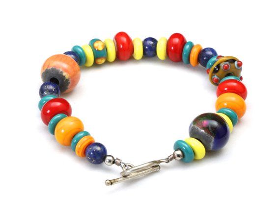 Vintage Lampwork Multicolor Beaded Bracelet-Very colorful and nicely mixed lampwork beads-4 of the beads are more intricate or multicolors, the rest are a solid color-Various shapes and sizes make up this bracelet-Toggle clasp in silver tone-Length approx 8.75"-Width: .6" widest bead-Weight: 35.3g-Very good vintage condition, beads are vibrant and colorful. Bracelet has not been cleaned Multicolor Czech Glass Gemstone Beads Bracelets, Multicolor Czech Glass Bracelets With Gemstone Beads, Multicolor Gemstone Beads Bracelet With Czech Glass, Multicolor Round Beaded Bracelets With Vibrant Style, Eclectic Multicolor Bracelet With Spacer Beads, Eclectic Multicolor Bracelets With Spacer Beads, Eclectic Multicolor Beaded Bracelets With Spacer Beads, Multicolor Czech Glass Hand-strung Beaded Bracelets, Artisan Multicolor Beaded Bracelets With Round Beads