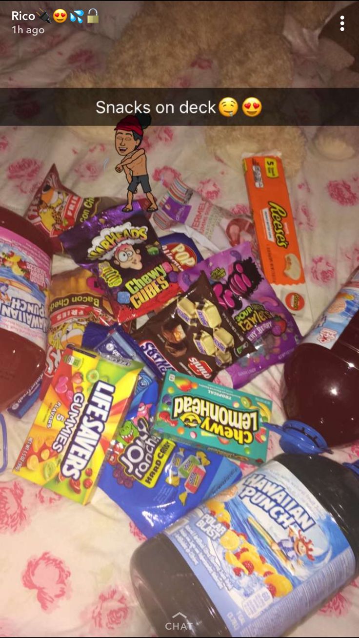 a bed topped with lots of candy and snacks