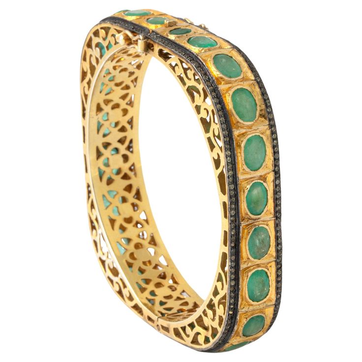 Emerald and Diamond Gold Bangle Bracelet. Behold the allure of this captivating Emerald and Diamond Gold Bangle Bracelet, a masterpiece of Indian craftsmanship. This exquisite bangle seamlessly combines the richness of gold with the vibrancy of emeralds and the brilliance of diamonds. Meticulously crafted, the piece reflects the timeless elegance of traditional Indian jewelry, making it a symbol of opulence and sophistication. The deep green emeralds and sparkling diamonds are intricately set, showcasing the artistry that defines Indian jewelry design. Elevate your style with this breathtaking blend of heritage and luxury—a true testament to the beauty of Indian work. Indian work. Total weight: 38.50 grams. Circumference approx. 18.00 centimeters. Thickness: 1.20 centimeters. Green Luxury Bangle Jewelry, Luxury Green Bangle Fine Jewelry, Luxury Emerald Bangle Bracelet, Luxury Green Carved Bangle, Luxury Green Gemstone Bangle, Traditional Indian Jewellery, Indian Jewellery Design, Gold Armband, Gold Bangle Bracelet