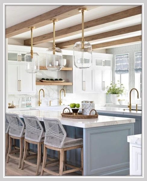 a kitchen with white cabinets and blue island in front of the countertop, surrounded by four bar stools