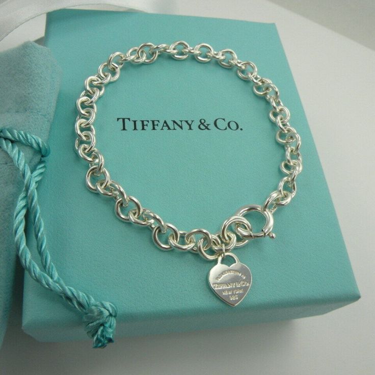 Brand New Authentic Tiffany & Co. Bangle Bracelet Including Tiffany’s Iconic Delicate Mini Heart Tag Charm. Solid 925 Sterling Silver And An Adult’s Size Medium Length Measuring 7 ~ 1/2” Long. Comes With The Tiffany & Co. The Original Box And Ribbon Are Included With Purchase. It Is In Perfect New Condition, Any Marks On The Photos Are Only Camera Glare . Note-->The Last Photo Shows The Multi Heart Bracelet, To Show What It Looked Like Before I Removed The All But One Heart. The Bracelet That Is Sterling Sliver Charm Bracelet, Tiffany And Co Bracelet Sterling Silver, Bracelets Tiffany & Co., Sterling Silver Tiffany, Tiffany Jewelry Tiffany & Co., Tiffany & Co. Bracelet, Tiffany And Co Bracelet Tiffany & Co., Tiffany Charm Bracelet Tiffany & Co., Tiffany And Co Bracelet Aesthetic