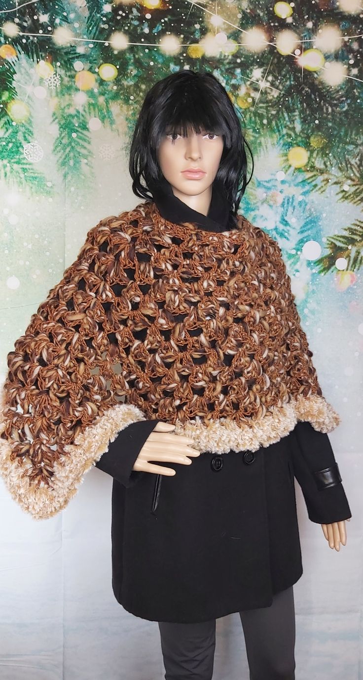 Hand crocheted poncho. Finished with faux fur. made with warm and soft alpaca wool with shades . enriched with a golden thread that makes this garment unique and fashionable. as you can see in the photos it can be worn both vertically and horizontally. Suitable for all women's sizes. The poncho is approximately 70 cm long and approximately 50 cm from the neck to the sleeve. For any information do not hesitate to ask. Brown Crochet Shawl For Fall, Fall Crochet Brown Shawl, One Size Beige Alpaca Poncho, Beige Alpaca Poncho One Size, Beige Alpaca One-size Poncho, Brown One Size Cape, Hand-knitted Brown Poncho For Fall, Hand Knitted Brown Poncho For Fall, Handmade Shawl Cape For Winter