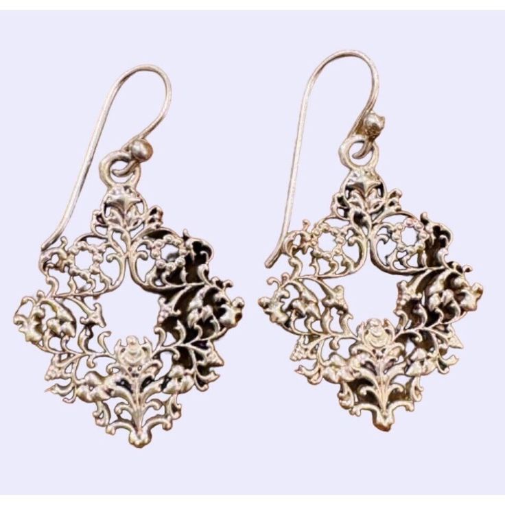 Barse Bridgeton Silver earrings are handcrafted in Thailand, showcasing a unique design. They offer a chic, timeless addition to any outfit, enhancing your style with a touch of elegance. Delicate small * Handcrafted in Thailand * Unique Bridgeton style * Made from genuine Silver * Timeless and versatile  * Ornate Wreath Style * Intricate and Delicate Size: Womens Over 1 inch Condition: Pre-Owned Good Elegant Metal Hoop Earrings With Filigree, Classic French Hook Earrings As Gift, Classic French Hook Earrings For Gifts, Elegant Silver Earrings With French Hook, Elegant Sterling Silver Chandelier Earrings Gift, Elegant Filigree Hoop Earrings As Gift, Classic Filigree Chandelier Earrings As Gift, Classic Filigree Chandelier Earrings For Gift, Victorian Style Nickel Free Earrings For Party