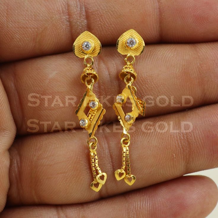 Elevate your style with these beautifully handcrafted gold earrings. Featuring a classic design and a comfortable fit, they add a refined touch to any look. Ideal for everyday wear or special occasions, they bring a subtle yet sophisticated sparkle. 18K Gold Dangle Earrings Metal is Real Gold Purity is 18kt Weight is 2.74 grams approx Max Length is 4.1 cm approx Max width is 0.7 cm approx ,  these earrings comes with normal backs, if you want real gold screw please contact. Please feel free to a Classic 22k Gold Earrings, Classic Gold Diamond Drop Earrings, Simple Design 14k Gold Earrings, Dainty Yellow Gold-plated Earrings, 14k Gold Classic Diamond Earrings With Elegant Design, Classic 14k Gold Diamond Earrings With Elegant Design, Dainty Yellow Gold Plated Earrings, Yellow Gold-plated Dangle Plug Earrings, Gold Plated Yellow Gold Dangle Plug Earrings