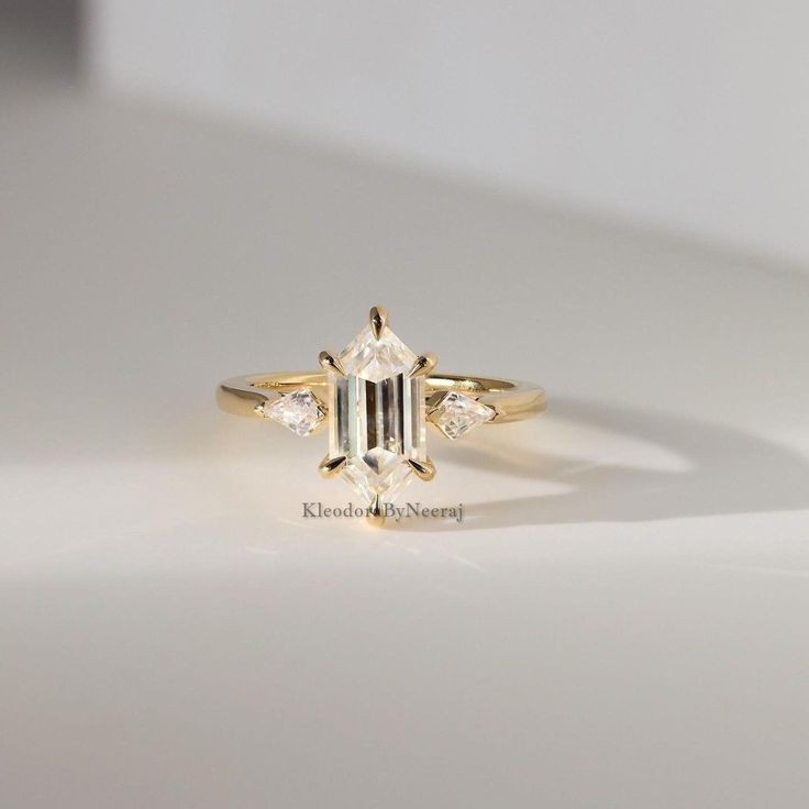 a diamond ring sitting on top of a white surface