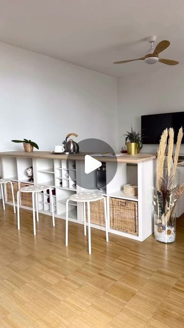 a living room filled with furniture and a flat screen tv on top of a wooden floor