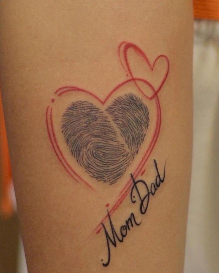 a woman's arm with a fingerprint heart and the word mom dad written on it