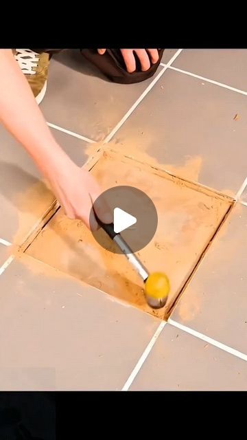 a person is using a plunger to remove the tile from the floor with a sponge