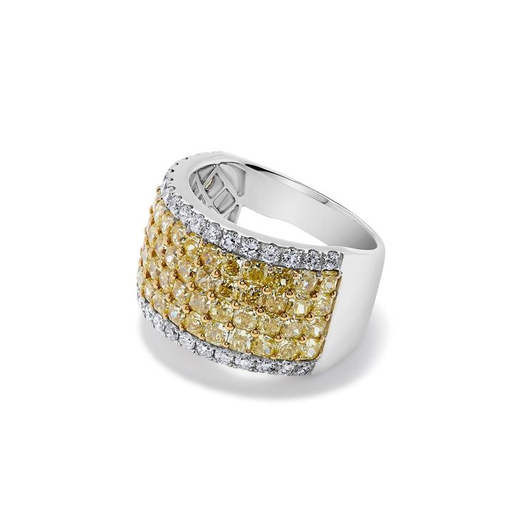 This exceptional ring features 60 radiant fancy yellow diamonds, totaling 3.95 carats, which exude a warm and captivating glow. Complementing these radiant yellow diamonds are 34 brilliant round white diamonds, totaling 0.71 carats, adding a touch of sparkle and contrast to the design. Perfect for making a bold and stylish statement, this cuff ring is sure to elevate any ensemble with its unique blend of colors and sophistication 60 Radiant Fancy Yellow Diamonds (3.95CT) 34 Brilliant Round Diamonds (0.71CT) 18KT Yellow and White Diamonds Luxury Yellow Rings With Single Cut Diamonds, Dazzling Yellow Diamond Ring With Accents, Dazzling Yellow Brilliant Cut Diamond Ring, Dazzling Brilliant Cut Yellow Diamond Ring, Luxury Yellow Diamond Ring With Pave Setting, Fine Jewelry Yellow Ring With Single Cut Diamonds, Yellow Diamond Ring With Pave Setting For Wedding, Formal Yellow Diamond Ring With Pave Setting, Yellow Single Cut Diamond Rings For Anniversary