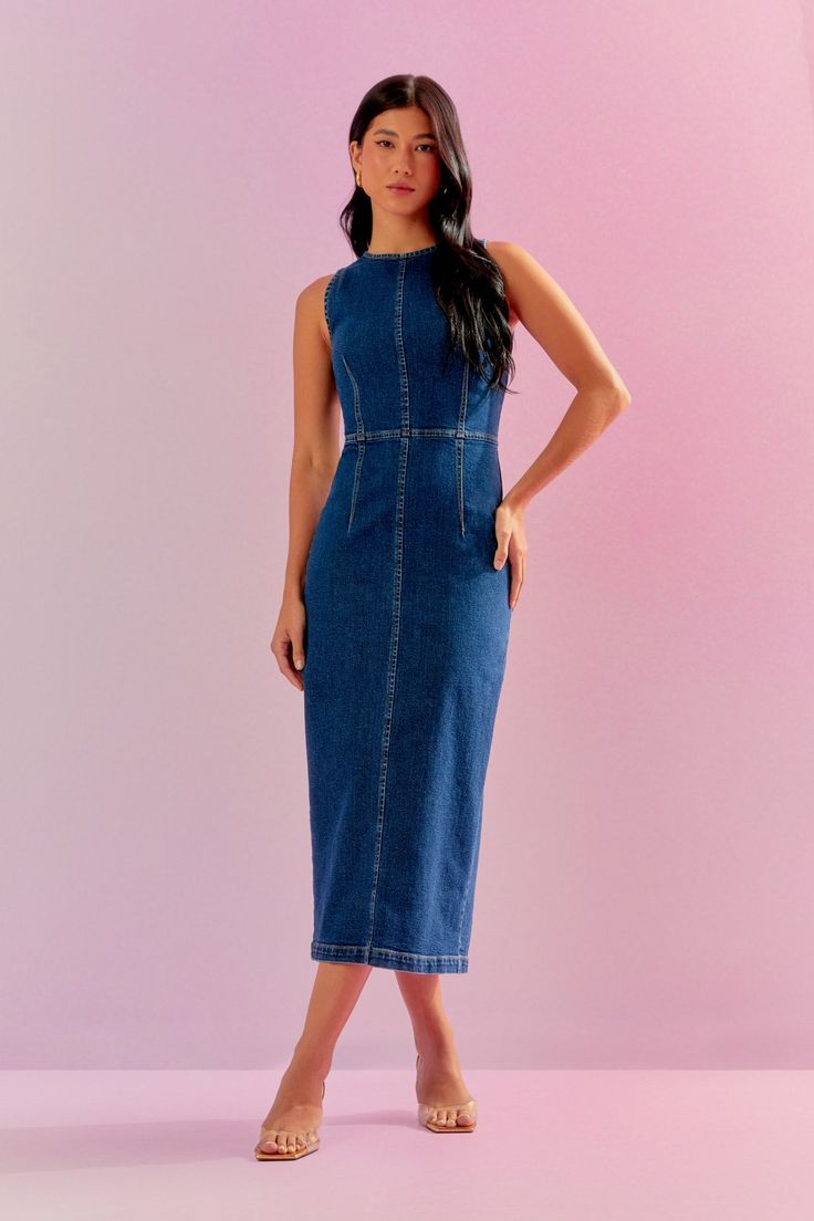 Classic Denim Midi Dress Elevate your wardrobe with this versatile denim midi dress, a timeless piece that seamlessly blends casual charm with sophisticated style. Made from high-quality denim, it features a flattering midi length that hits just below the knee. The dress is designed with a fitted bodice, a cinched waist for an hourglass silhouette, and a button-down front for a touch of classic appeal. Detailed with stylish pockets and a slight A-line skirt, this dress offers both practicality a Spring Midi Dress Medium Wash For Work, Fitted Dark Wash Denim Midi Dress, Denim Blue Midi Dress For Summer Workwear, Chic Denim Midi Dress For Work, Chic Dark Wash Knee-length Midi Dress, Fitted Midi Dress In Medium Wash For Work, Chic Mid-length Denim Dress For Work, Chic Knee-length Dark Wash Midi Dress, Chic Knee-length Denim Dress