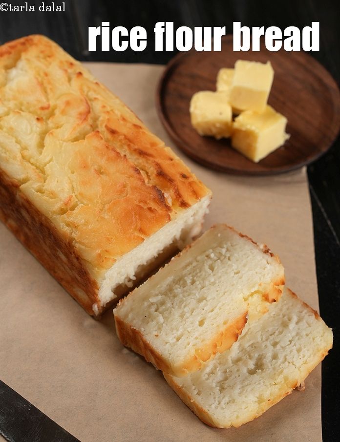 a loaf of bread sitting on top of a piece of paper next to a knife