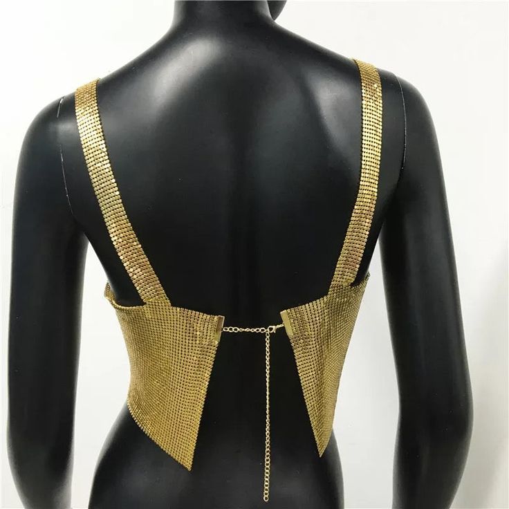 Metal halter top. SIZE Bust: 30”-38 Length: 6,69” Chic Triangle Top For Club, Gold Tank Top For Summer Club Events, Chic Triangle Top Tank For Night Out, Gold Fitted Cami Top, Backless Party Top With Straps, Chic Tank Straps Crop Top For Party, Trendy Party Crop Top With Tank Straps, Chic Crop Top With Tank Straps For Party, Fitted Tank Crop Top For Evening