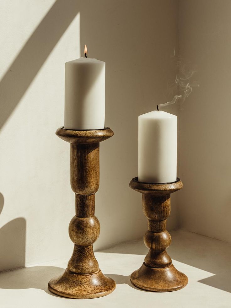 Wooden candle holders; one large and one small. Holder hold white candle on a white table. Wood Candle Stand, Wooden Candle Stands, Candle Holders Decor Ideas, The Exploited, Pillar Candle Stand, Wooden Candle Stand, Wooden Ideas, Pillar Holders, Candle Stands