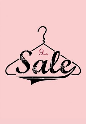 a pink background with the word sale hanging on a hanger