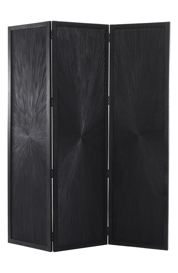 a black room divider with an intricate design on the front and back panels,