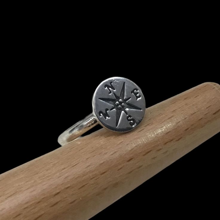 This is a sweet and shiny Sterling Silver Rose Compass Ring.  The compass is a 925 Sterling Silver 10mm round disc.  The handmade 925 Sterling Silver band is made to order and made in our Ohio studio.  It is the perfect stacking ring and gift for someone going on a trip or beginning a new  life journey after school or marriage...find your journey! Thank you for visiting our shop. Gift Signet Ring With Compass Design, Symbolic Rings With Compass Design For Gift, Symbolic Rings With Compass Design As Gift, Symbolic Compass Design Ring As Gift, Nickel Free Signet Ring As Gift, Sterling Silver Compass Design Ring, Stamped Sterling Silver Signet Ring, Sterling Silver Rings With Compass Design For Anniversary, Adjustable Nickel-free Engraved Ring