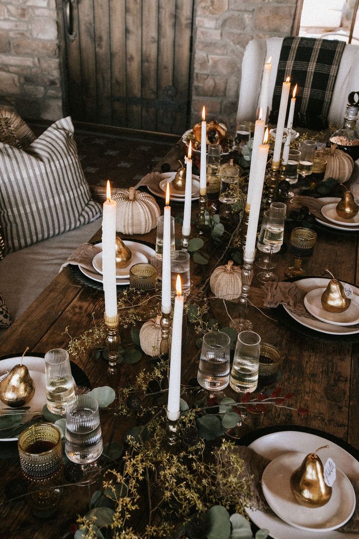 the table is set with candles and plates